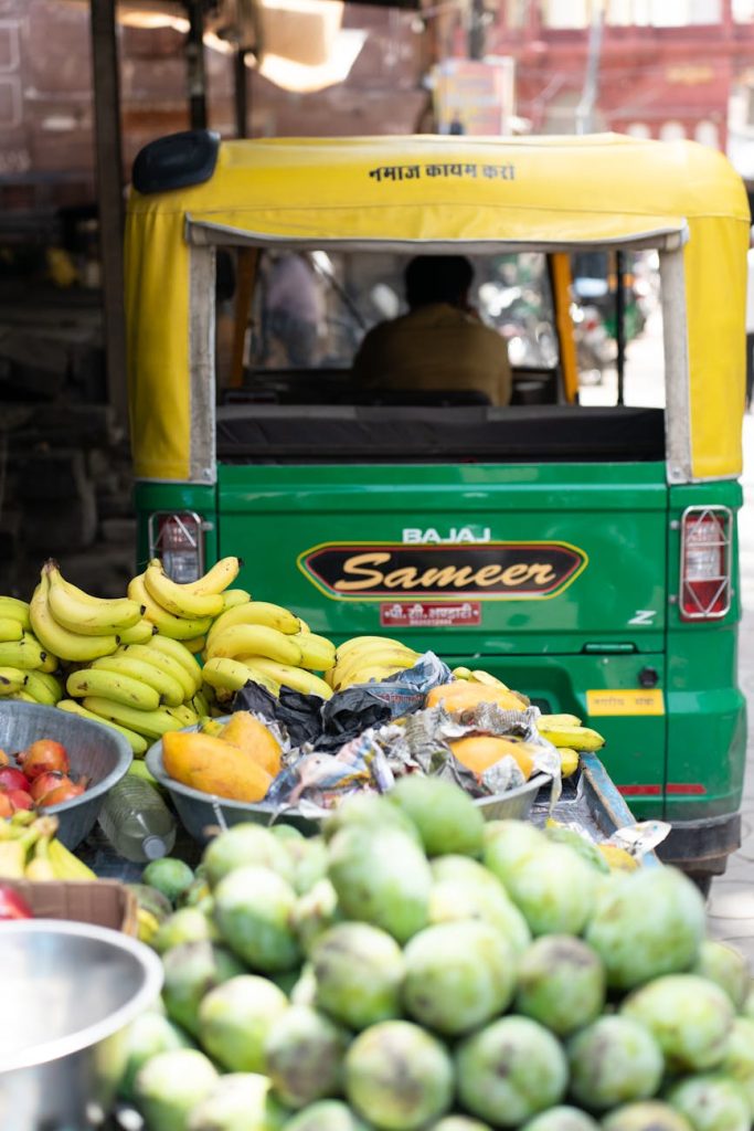Vibrant scene of fruits and an auto rickshaw in a Jodhpur street market.